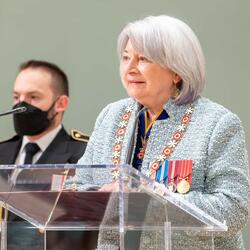 The Governor General is standing at a podium.