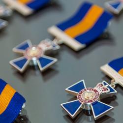 The badge of the Order of Merit of the Police Forces displayed on a table. 