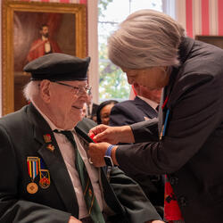 Governor General Mary Simon pins a poppy on a veteran