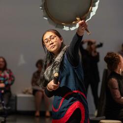 An Inuit women performs a cultural music piece
