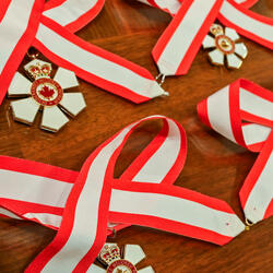 Decorations of the Order of Canada on a table.