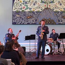 Musicians playing in the Rideau Hall Ballroom. A large painting is on the wall behind them.