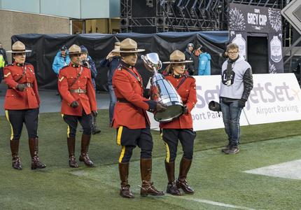 Members of the RCMP carried the Grey Cup onto the field.