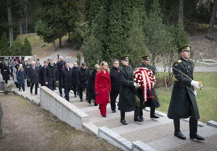 The Governor General and the delegation walk in a procession to the monument. 