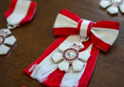 A photo of the Order of Canada insignia.