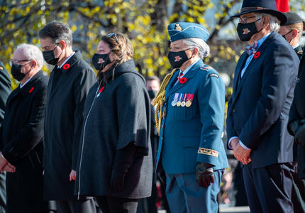 Several people are standing one beside the other outdoors. Mr. Whit Fraser, Governor General Mary Simon, and Ms. Josée Simard (the National Silver Cross Mother) are among them.