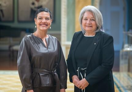 Governor General Simon is standing next to Her Excellency Adriana Solano Laclé.