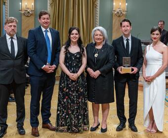 Governor General Simon stands with a group of recipients of the Michener Award. They are in the Ballroom at Rideau Hall.