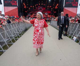 Governor General Marie Simon walks and waves to the crowd gathered for the Canada Day celebration.