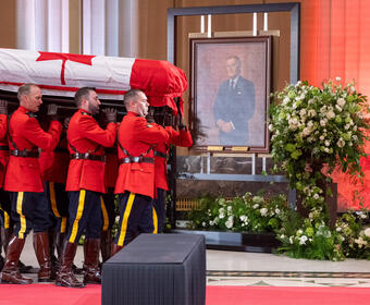 RCMP officers enter with the casket of the Right Honourable Brian Mulroney