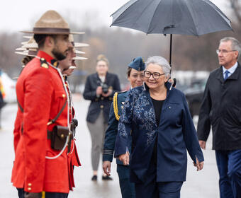 Governor General Mary Simon inspects a guard of honour made up of members from the Royal Canadian Mounted Police
