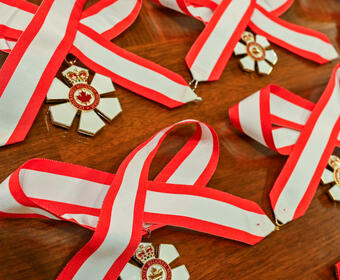 Decorations of the Order of Canada on a table.