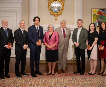Governor General Mary Simon and Mr. Whit Fraser standing with six Governor General Innovation Award recipients.